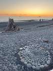 Rialto Beach, Olympic Peninsula, Washington. Pebbles arranged in a circle on the beach. Sunset. Art Print